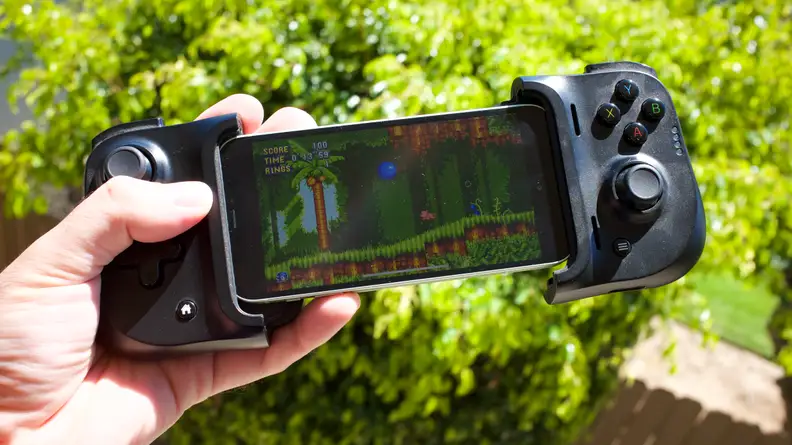 An iPhone 12 Mini docked into a Razer Kishi controller, playing Sonic Mania through Amazon Luna