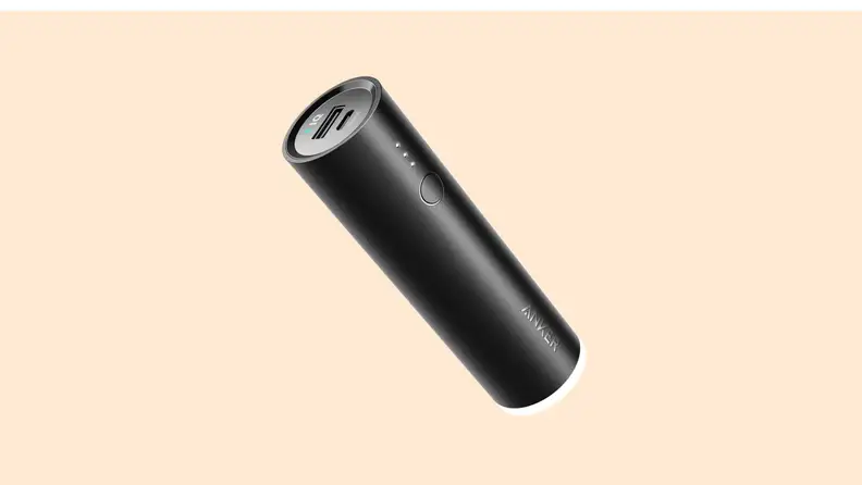 A PowerCore+ Mini Portable Charger on a vanilla-colored background.