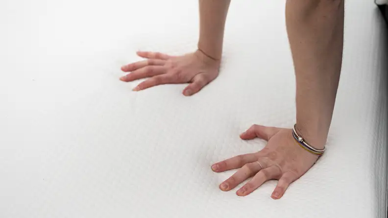 hands press into the lull original's surface