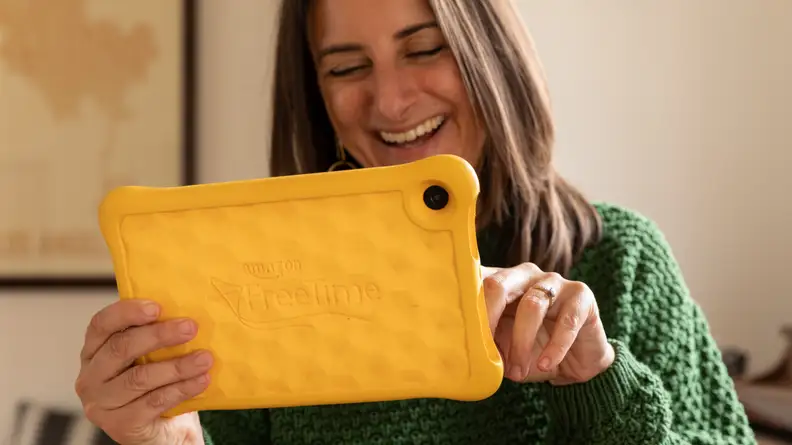 A woman uses an Amazon Kindle Fire tablet