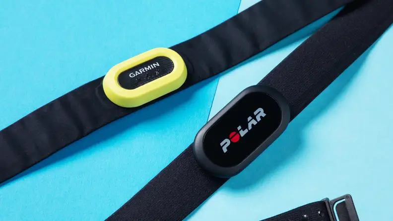 The Garmin HRM-Pro vs Polar H10 side-by-side on a blue background.
