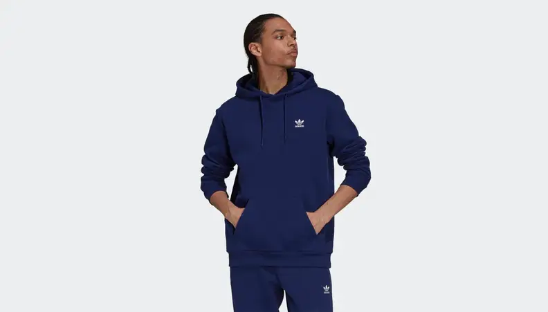 A person wears a dark blue hoodie.