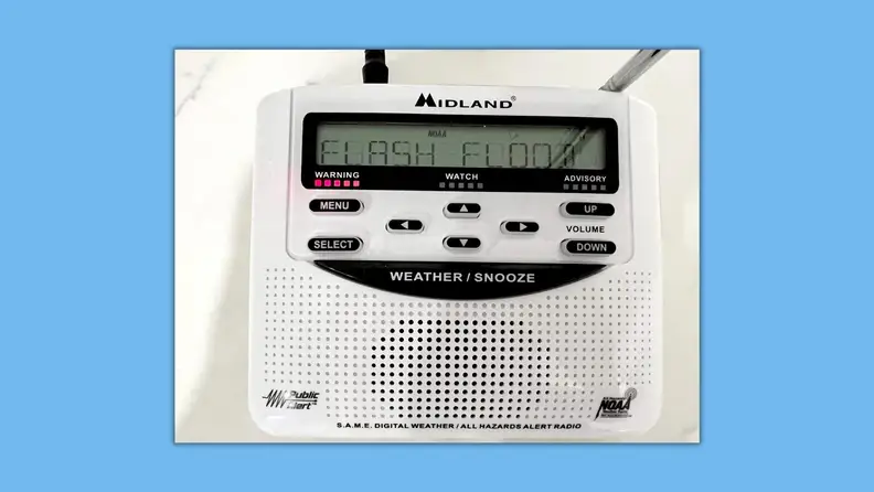 The weather radio with a flash flood warning on display.