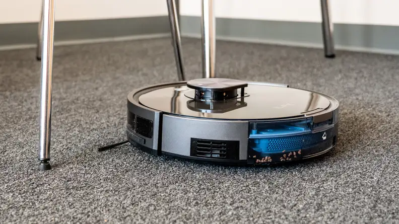 The iLife A10 attempting to go through a set of chair legs