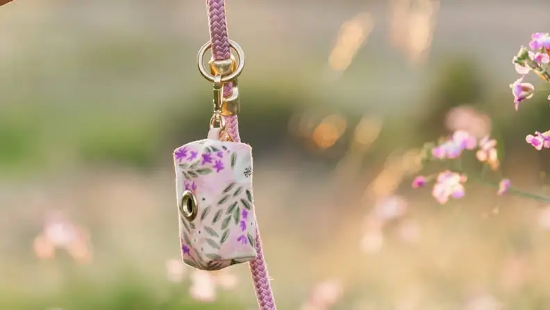 An image of a floral printed dog waste bag.