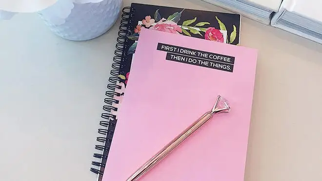 A pink notepad that says "First I drink the coffee. Then I do the things."