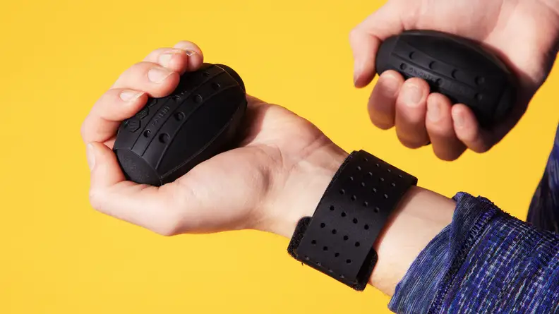 Person wearing Liteboxer wrist straps holds egg shaped weights.