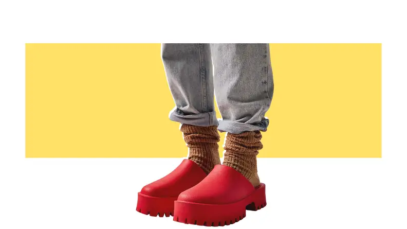 A model wearing bright red platform clogs.