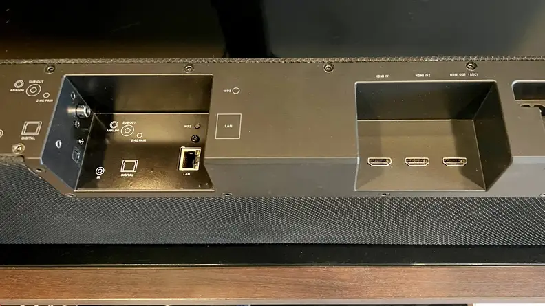 The black inputs section at the back of the bar shows multiple connections, including dual HDMI 2.1 and HDMI ARC
