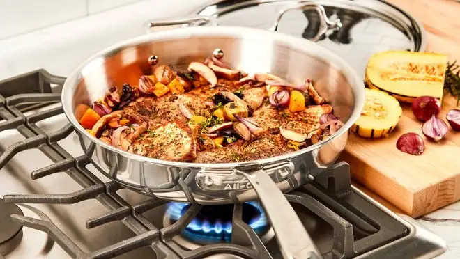 Pan cooking tasty meal on top of burning cooktop.