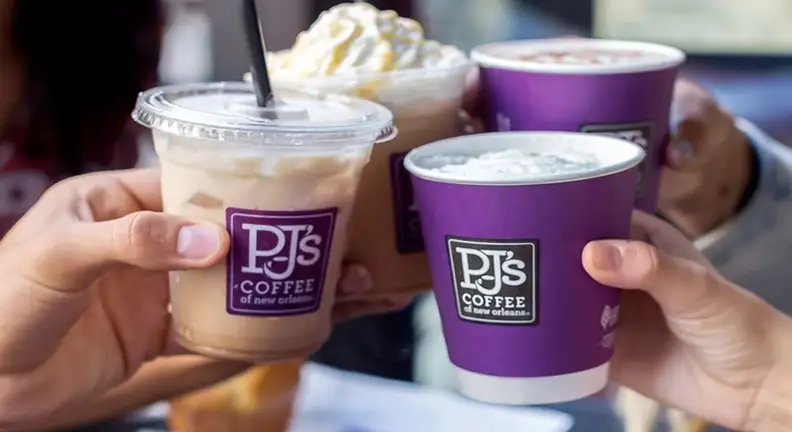 Hands holding iced and hot coffee cups together