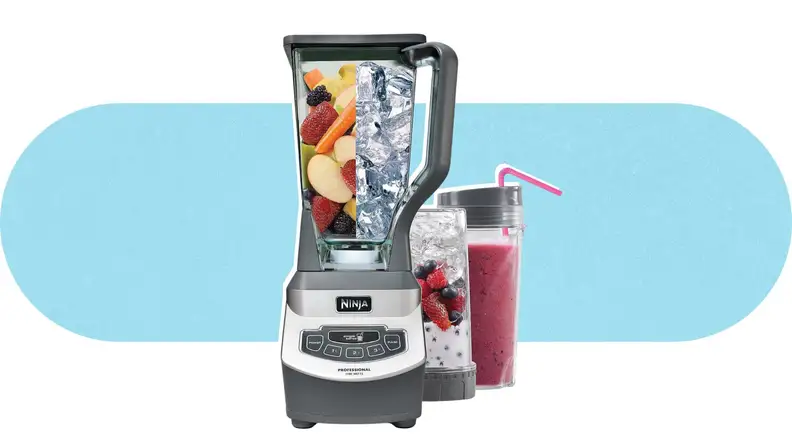 The Ninja BL660 Blender filled with ice and fruit next to two filled smoothie cups.