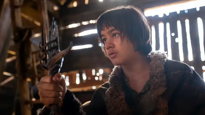 An image of Theo holding an artifact of Sauron, shaped like a sword handle.