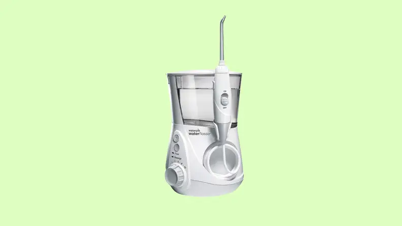 The Waterpik watter flosser appears over green.