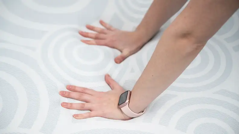 A pair of hands on the Serta Perfect Sleeper