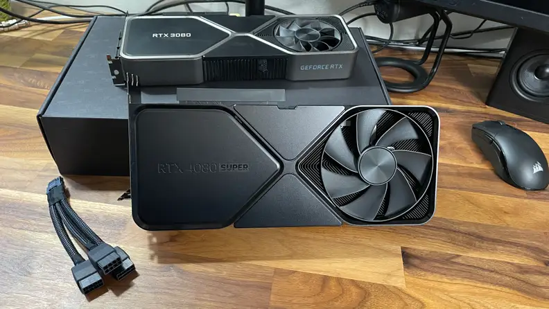 A black graphics card next to a silver 3080