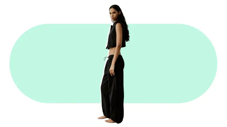 A model wearing baggy parachute pants.