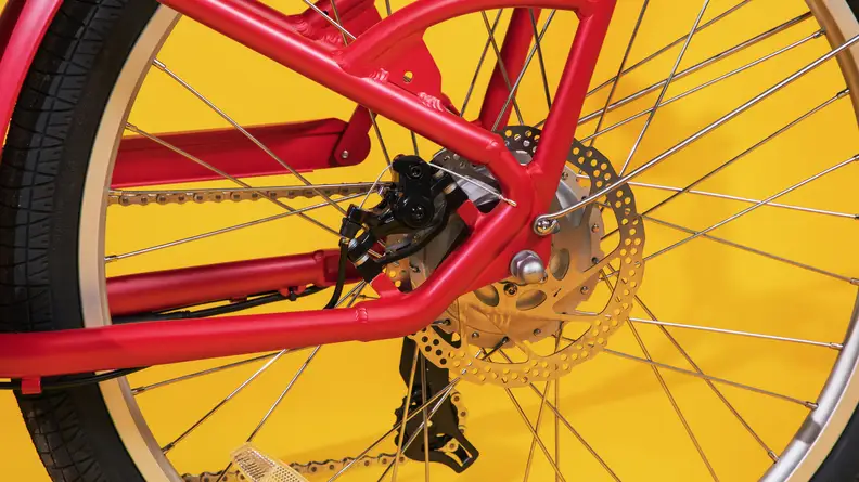 The rear wheel of the Radio Flyer Cruiser e-bike showing the hub motor and brake disc