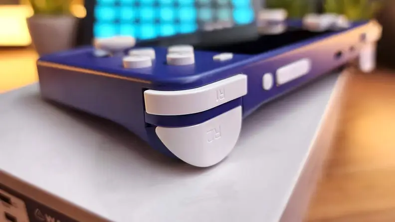 Close up side view of the Retroid Pocket 2S handheld showcasing the triggers, buttons and bumpers.
