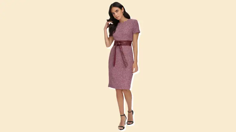 A sheath dress from Calvin Klein against a manila background.
