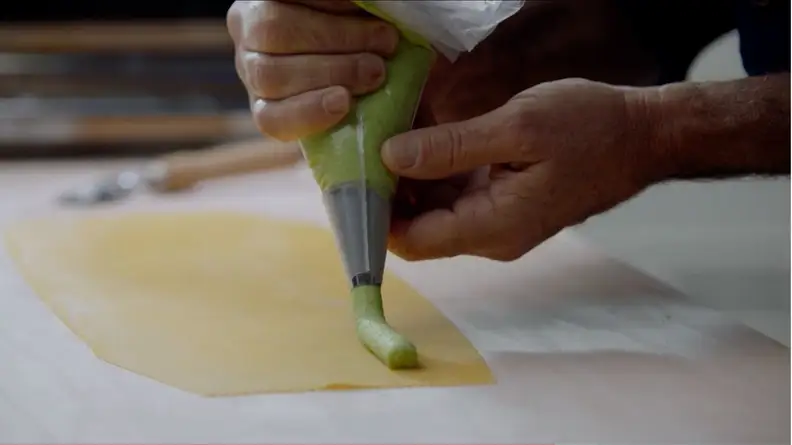 Pasta Agnolotti with Peas and Bacon being filled