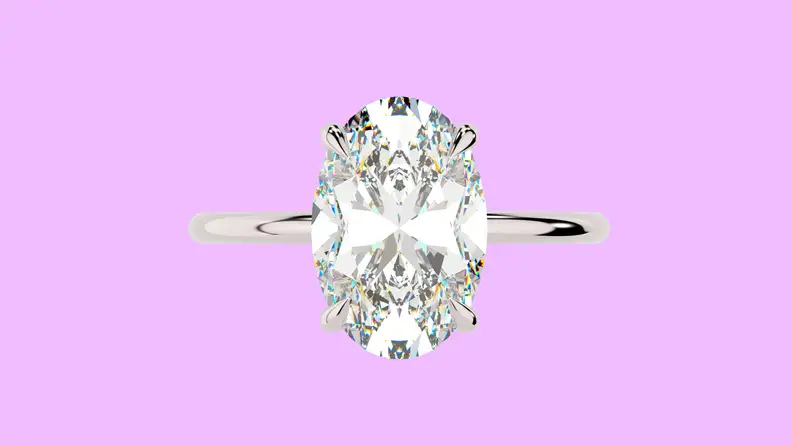 Photo of the East West Gem Co. The Harper Ring against a purple background.