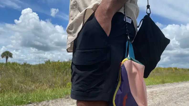man with hand inside of pockets