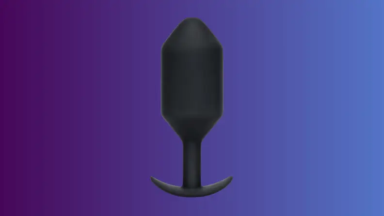 An anal sex toy sits on an indigo fade background