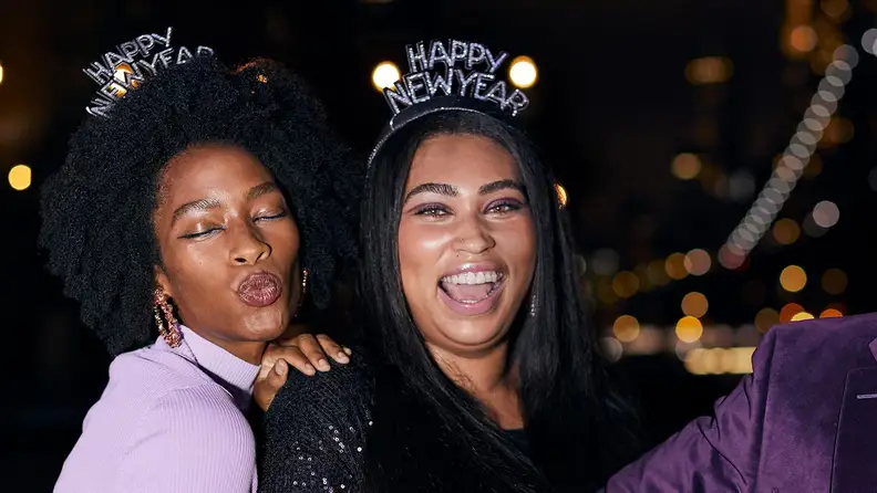Two people celebrate New Year's Eve at night.