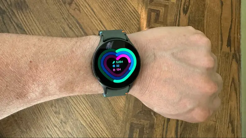 Close-up of a wrist wearing the smartwatch displaying a heart monitor.