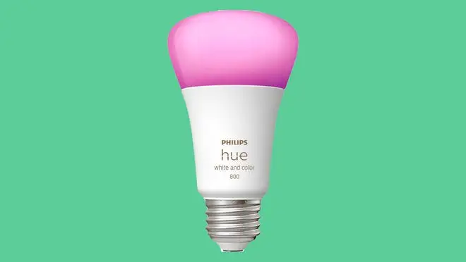 Pink smart bulb on green background