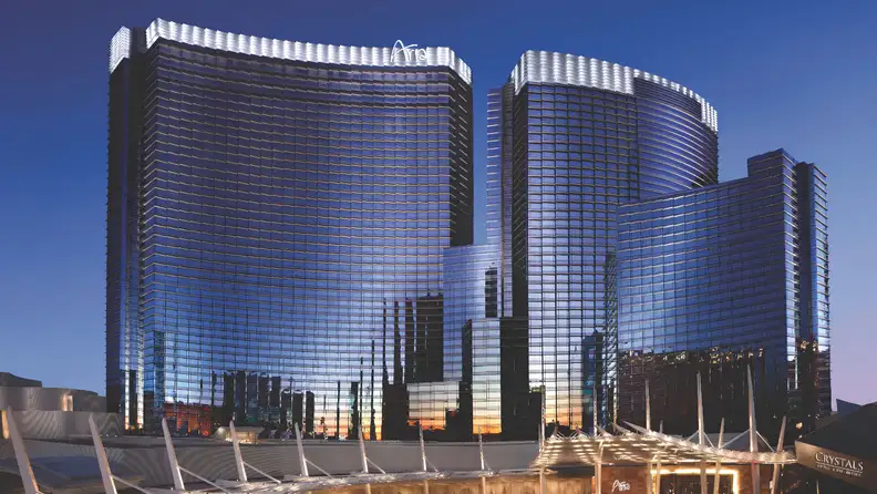 ARIA Resort & Casino’s sleek glass towers reflecting the Las Vegas skyline at sunset, viewed from the entrance and surrounding CityCenter complex.