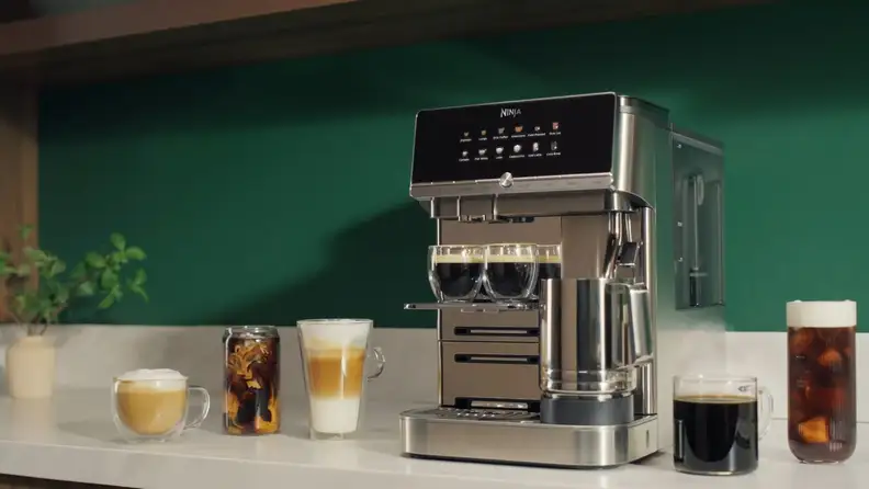 Ninja espresso machine surrounded by lattes, iced coffee and espresso drinks