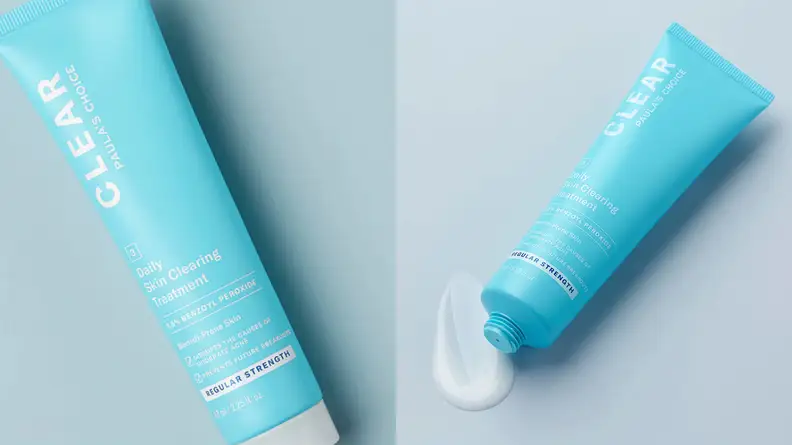 On the left and right: A slim, light blue squeeze tub laying diagonally on a gray background.
