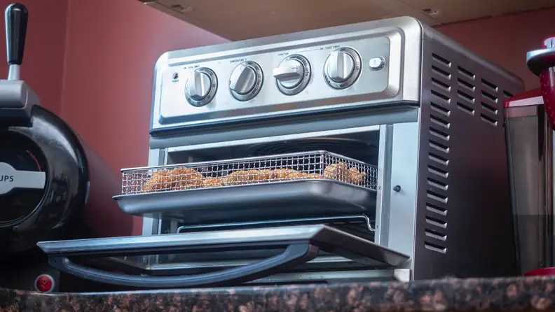Cuisinart Air Fryer Toaster Oven sits on a kitchen counter.