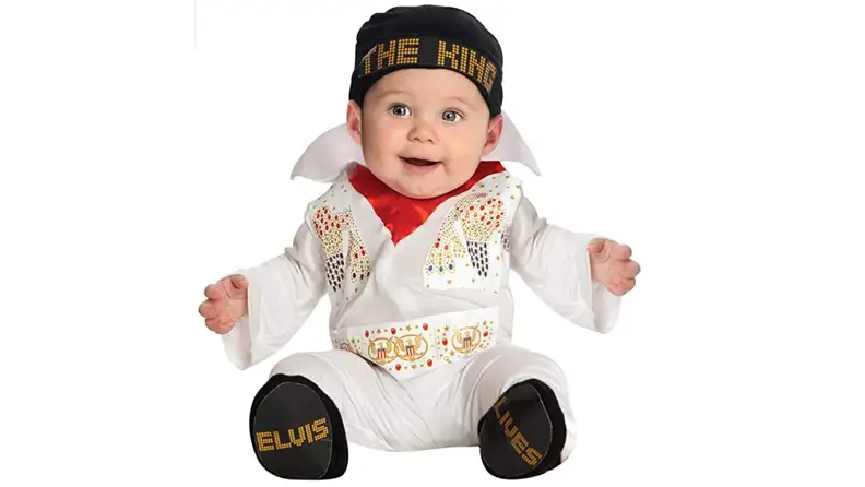 A baby dressed in an Elvis costume.