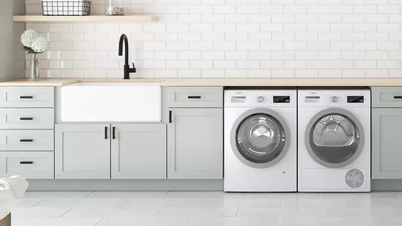 Matching washer and dryer in modern laundry room.