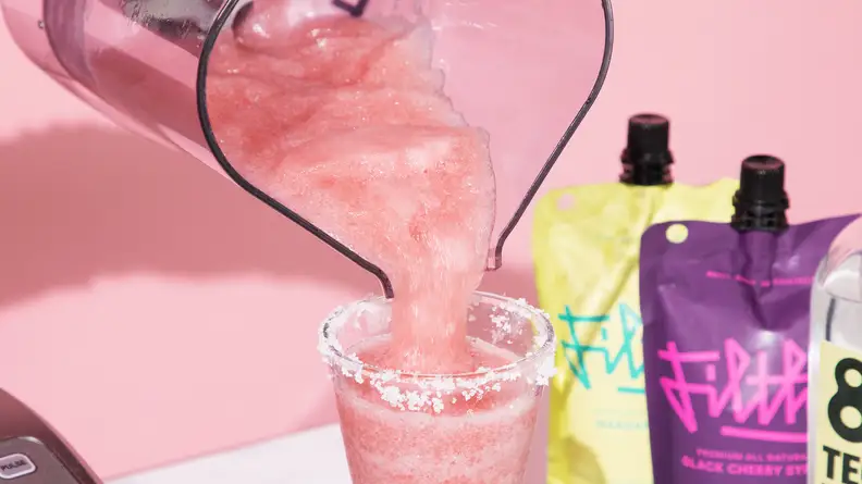 black cherry margarita mix being poured into cup