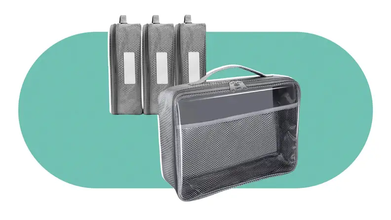 Four grey toy storage bags on a green background.