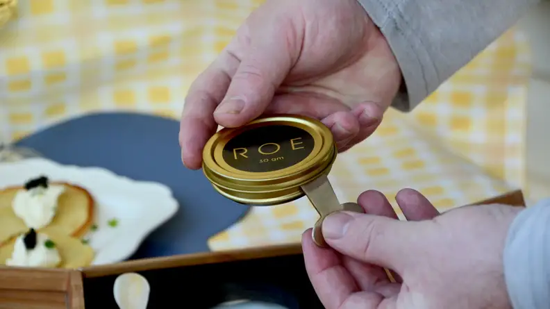 The gift set comes with a tin opener and a mother of pearl spoon.