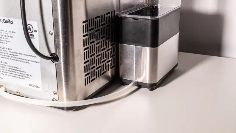 The Opal Nugget Ice Maker drain hose connects to the side tank via a spout in the back.