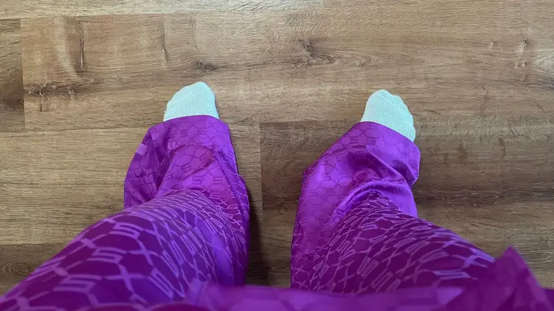 Man wearing baggy purple Savage X Satin Pants.