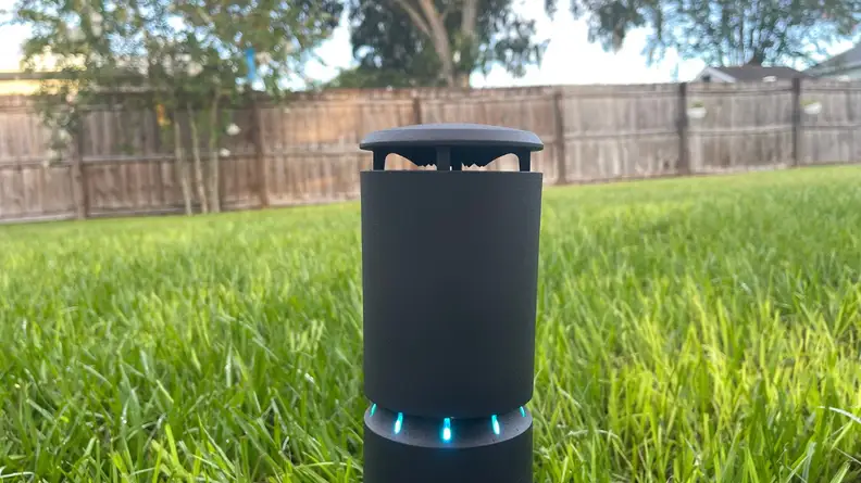 The LlV mosquito repeller sitting in the ground displaying blue lighs