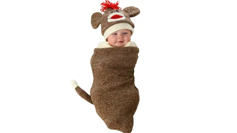 A baby wrapped in a monkey costume.