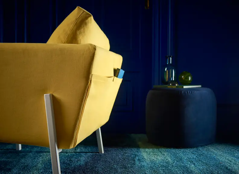 A bright, comfortable chair brightens a dark room.