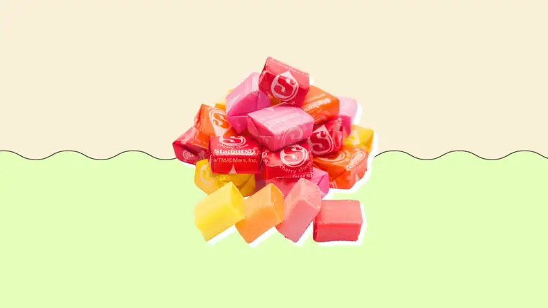A pile of Starbursts on a green and beige background