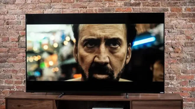 Vizio television with Nicholas Cage movie playing on screen.