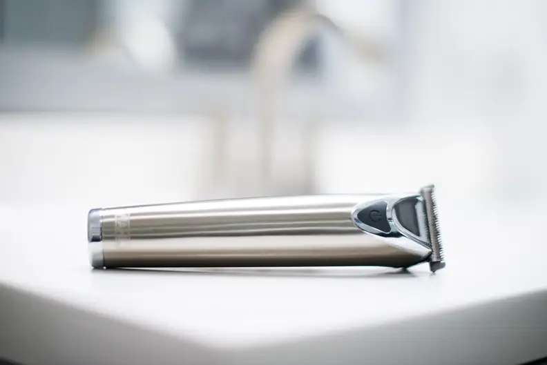 A Wahl 9818 Stainless Steel Lithium beard trimmer sitting on the corner of a counter