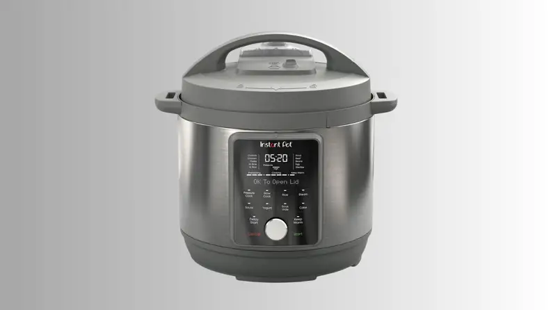 An Instant Pot cooker sits on a gray ombre background