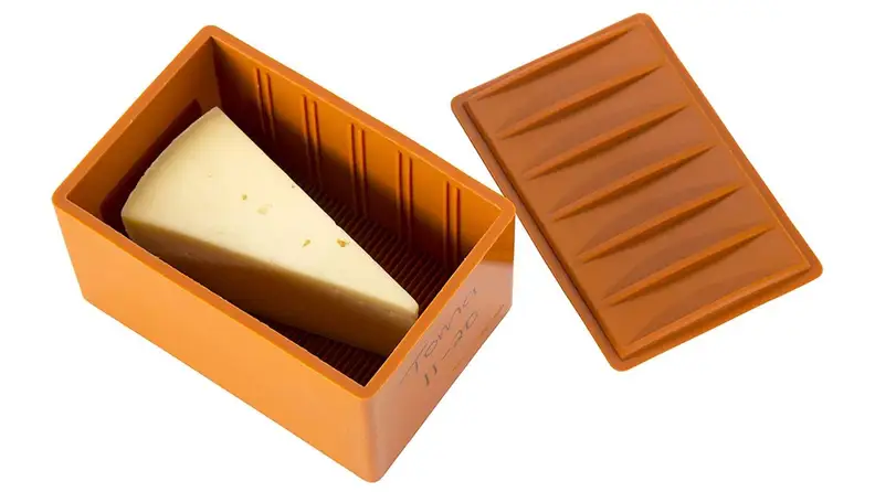 A large wedge of cheese is shown being stored in Capabunga's silicone Cheese Vault.